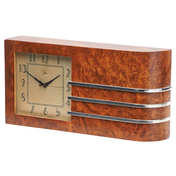 GILBERT ROHDE; HERMAN MILLER World's Fair Clock: GILBERT ROHDE (1894 - 1944) HERMAN MILLER World's Fair Clock, Zeeland, MI, 1933; Burlwood veneer, chrome plated-steel; Brass tag, signed on face; 6 3/4" x 13 1/4" x 2 1/2"