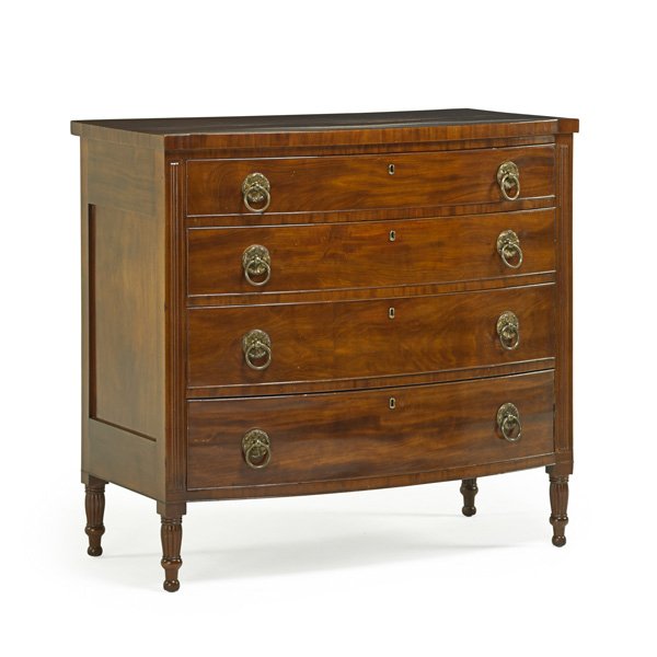 SHERATON BOWFRONT CHEST OF DRAWERS: Mahogany with corner columns and ring pulls, early 19th c.; 39 1/2" x 42" x 22 1/2"