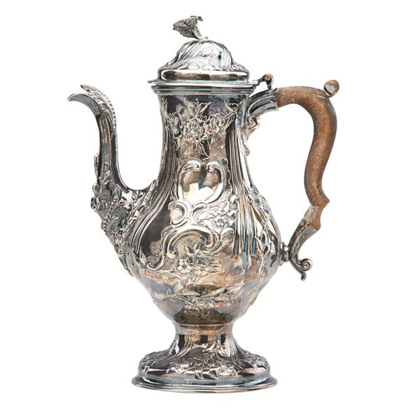 GEORGE II REPOUSSE SILVER COFFEE POT: Foliate decoration and treen handle; Marked for William Holmes, London, 1767; 35 OT, 12"