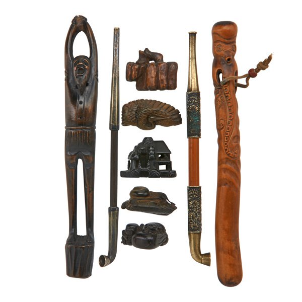 JAPANESE OPIUM PIPES AND NETSUKE: The two pipes and five netsuke with carved figural and animal decoration, 19th/20th c.; Pipe holders: 8"