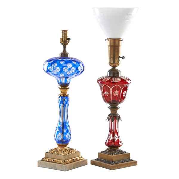 BOHEMIAN OVERLAY GLASS TABLE LAMPS: One in ruby and one in blue on marble bases, electrified, 19th c.; Taller: 24" (with shade)