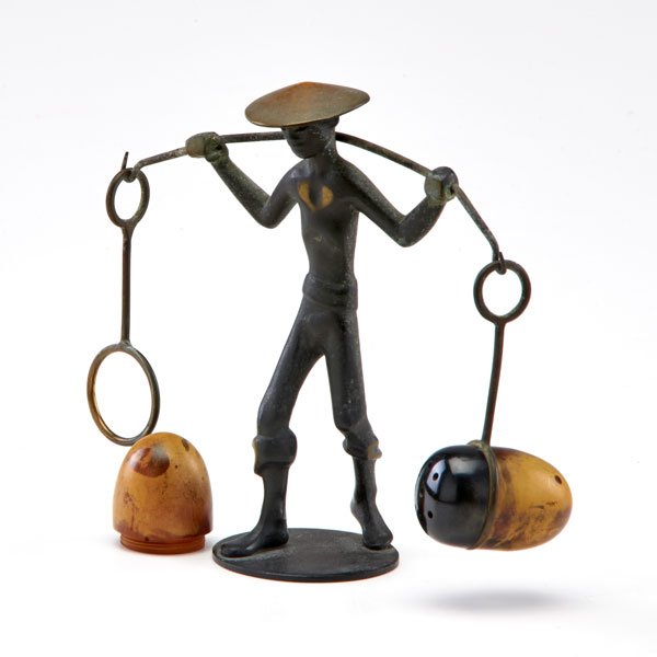 FRANZ HAGENAUER; RICHARD ROHAC: Bronze figure of an Asian man carrying Bakelite salt and pepper shakers, mid 20th c.; Marked.; 4 1/2" x 5" x 2"