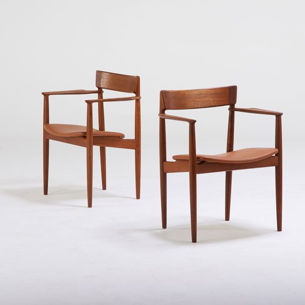 GRETE JALK; POUL JEPPESEN: Pair of armchairs, Denmark, 1950s; Sculpted teak and leather; Branded; Each: 30" x 24" x 20"