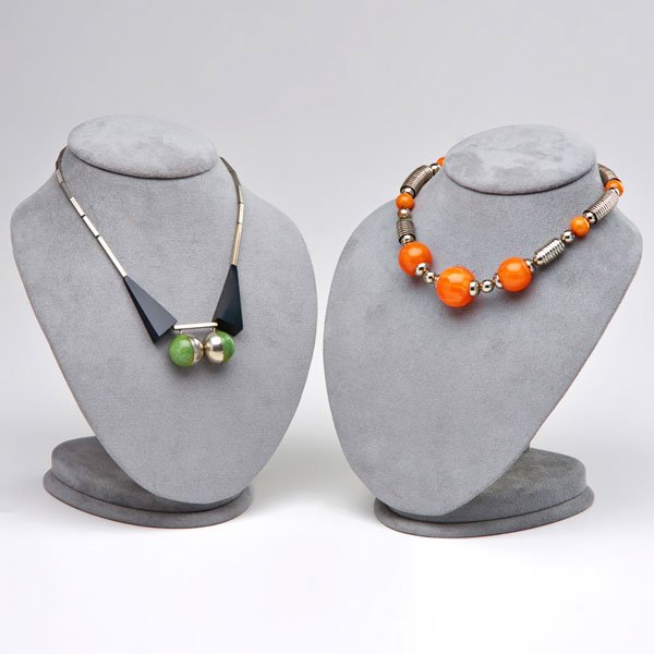 TWO JACOB BENGAL BAUHAUS NECKLACES WITH GALALITH: Orange colored Galalith bails with bright chromed spherical and stacked half circle stations, 16 1/2"; Rectangular silver tone links suspend black Galalith triangular links and two half green/half sil