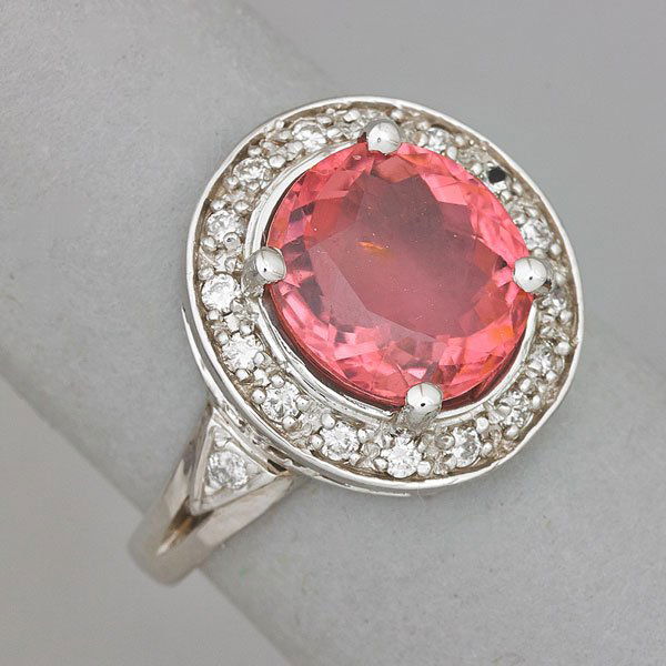 CONTEMPORARY RUBELLITE TOURMALINE AND DIAMOND RING: Oval faceted rubellite tourmaline, 5.15. cts. by formula, diamond halo and shoulders, .18 ct. TW; Size 8 1/2; 4.2 dwt.