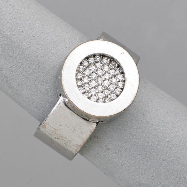 CHANEL, PARIS DIAMOND 18K GOLD "ROTUNDA" RING: Geometric form, 40 diamonds pave disc and broad hoop; French marks, engraved Chanel 54, #112914, 50; Ca. 2000; Size 7; 9.1 dwt.; Original box.