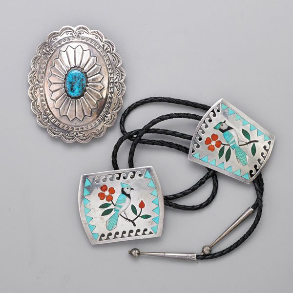 NATIVE AMERICAN STERLING GENTLEMEN'S JEWELRY: Three pieces: Sammy's Esther Guardian Zuni inlaid blue jay on branch bolo tie and buckle, includes turquoise marcasite and spiny oyster, 2 5/8" x 2 1/4" and 2 1/2" x 2 1/4"; Navajo stamped and embosse