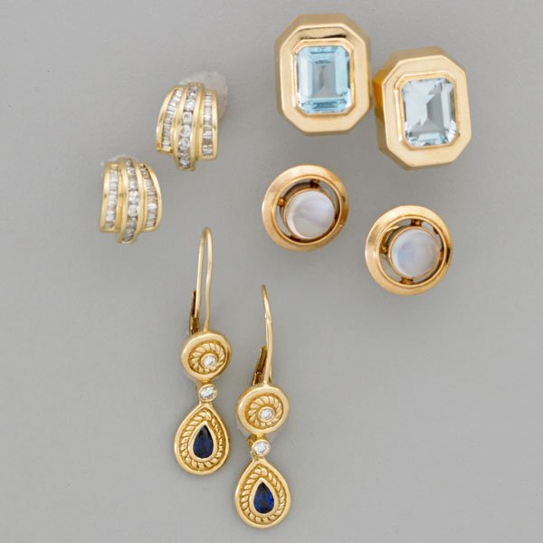 FOUR PAIRS 14K YELLOW GOLD EARRINGS: Octagonal faceted blue topaz; Moonstone cabochons; Two round brilliant cut diamonds suspending pear shaped sapphires, in bezel settings with "rope" motif surround; Rows of baguette and round brilliant