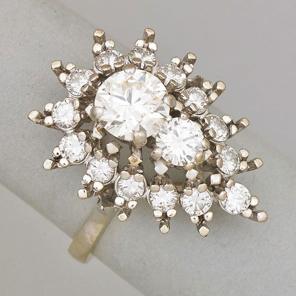 DIAMOND 14K WHITE GOLD COCKTAIL RING: Pear shaped cluster, principle transitional cut diamond approx. .90 ct., brilliant cut diamond approximately .30 ct., approx. 2 cts. TW throughout, ca. 1960; Size 6; 3.5 dwt.