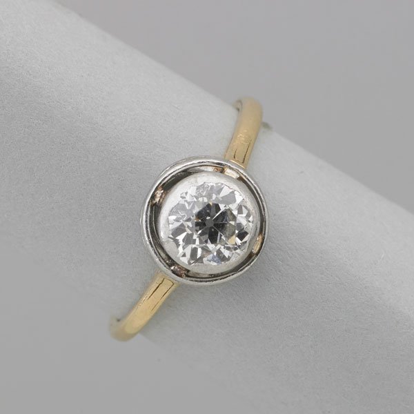 OLD EUROPEAN CUT DIAMOND ENGAGEMENT RING: OEC .80 ct. bezel set in platinum within knife edge halo, 14k yg. hoop, ca. 1902; Size 5; 1.5 dwt., possibly Tiffany & Co.