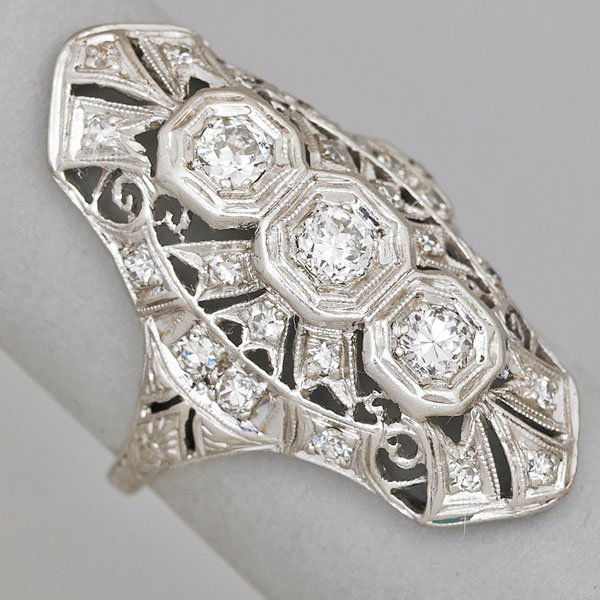 PLATINUM AND DIAMOND FILIGREE RING: OEC and transitional cut diamonds in navette form, three central diamonds approx. .15 ct. each, approx. .95 ct. TW throughout; Size 5 1/2; 3.5 dwt.