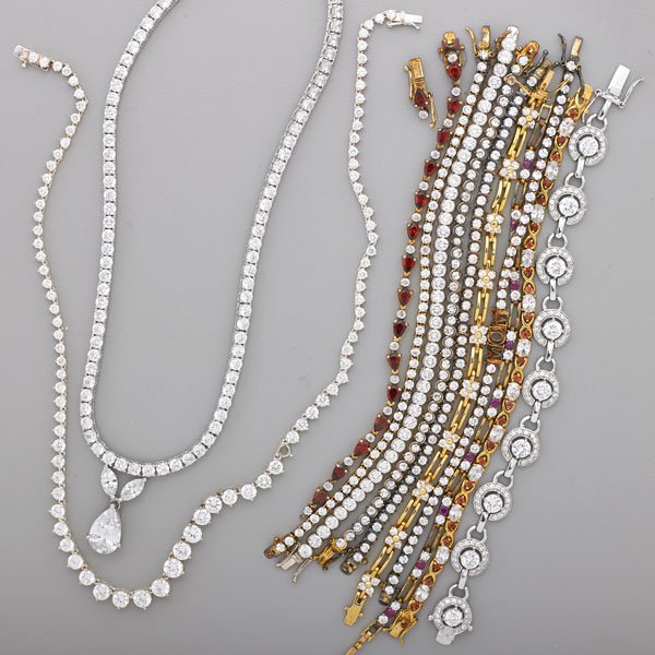COLLECTION OF STERLING TRAVEL JEWELRY: Twelve pieces: Ten sterling silver rhinestone and "rubies" bracelets, average length 7"; "Diamond" Rivière necklace, 17 1/2"; Pear shaped "diamond" drop necklace; 5.9 OT