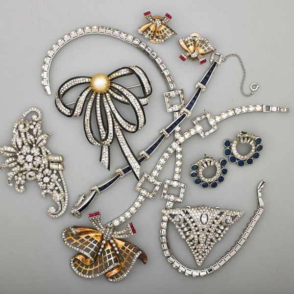 ELEGANT RHINESTONE AND STERLING COSTUME JEWELRY: Eleven pieces, all sterling, some enameled and multi “gem” set: Three brooches, fur clip, two pairs of earrings, necklace, two bracelets; 1938-1958; Makers include Trifari, Mazer, Dorson’s, etc.