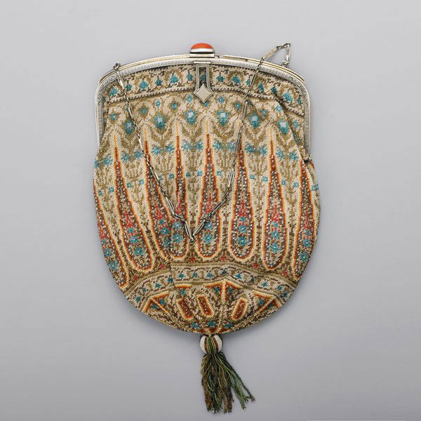 EDWARDIAN CAVIAR BEAD EVENING BAG: Chased silver frame and fetter link chain handle with coral slide closure, pouch in Persian design with beaded tassel, cream satin interior, accompanying change purse, ca. 1910; 9 1/2" x 5 1/2"