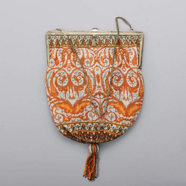 EDWARDIAN CAVIAR BEAD EVENING BAG: Chased silver frame and fetter link chain handle with cabochon sapphire slide closure, pouch in Persian design with beaded tassel, cream file interior, accompanying mirror and envelope cover, ca. 1910