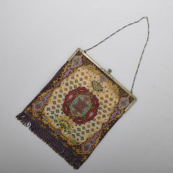 EDWARDIAN CAVIAR BEAD EVENING BAG: Chased silver frame and fetter link chain handle with cabochon sapphire slide closure, pouch in Persian design with beaded tassel, cream file interior, accompanying mirror and envelope cover, ca. 1910