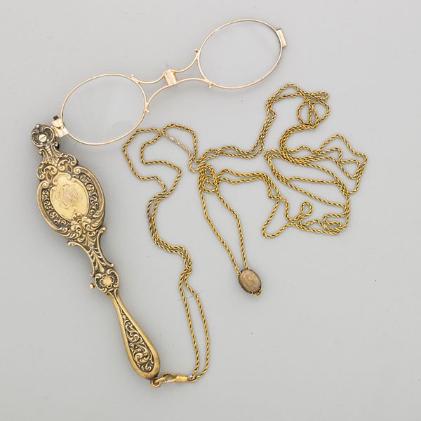 EDWARDIAN EMBOSSED 14K GOLD LORGNETTE, KREMENTZ: Hinged spectacles in rococo sprung handle, dated 1907, monogrammed, 4 3/4", accompanied by g.f. chain with diamond slide, 50"; 20.2 dwt. GW (lorgnette alone)