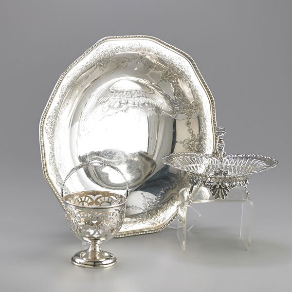 AMERICAN ORNAMENTAL EDWARDIAN STERLING: Three pieces: Frank Whiting footed fruit bowl with incised scroll, festoon and applied gadroon edge, 12"; Whiting Mfg. Co. fixed handle pierced sweetmeat basket, 6 1/8"; Graff, Washborne & Dunn swing 