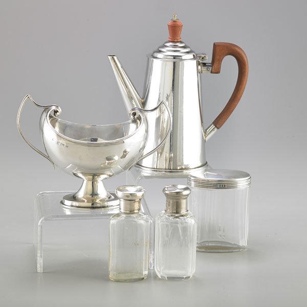 ENGLISH SILVER OR SILVER-MOUNTED ACCESSORIES: Five pieces: Boat-shaped footed silver sugar bowl with upswept handles, Birmingham, 1904, indistinct maker mark, 6 1/2" across handles; Tapered silver cylindrical coffee pot, Sheffield, 1946, 7"; Thre