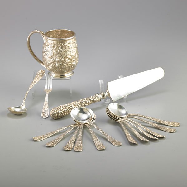 SILVER REPOUSSE UTENSILS AND A CUP: Sixteen pieces: Set of twelve sterling repousse small round bouillon spoons, The Stieff Company, Baltimore, MD, 20th c., 5 1/2"; Coin silver floral repousse 11 oz. cup, S. Kirk & Son, Baltimore, MD, 1