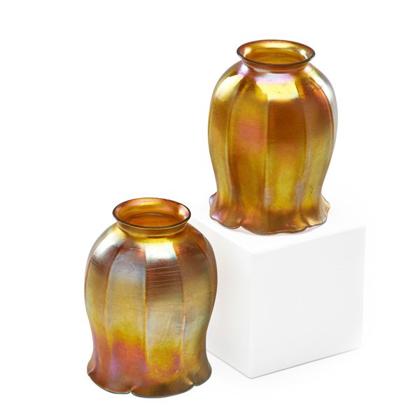TIFFANY STUDIOS Pair of gold Favrile glass shades: TIFFANY STUDIOS Pair of gold Favrile glass shades, New York, 1900s; Etched L.C.T.; 5" x 3 1/2"