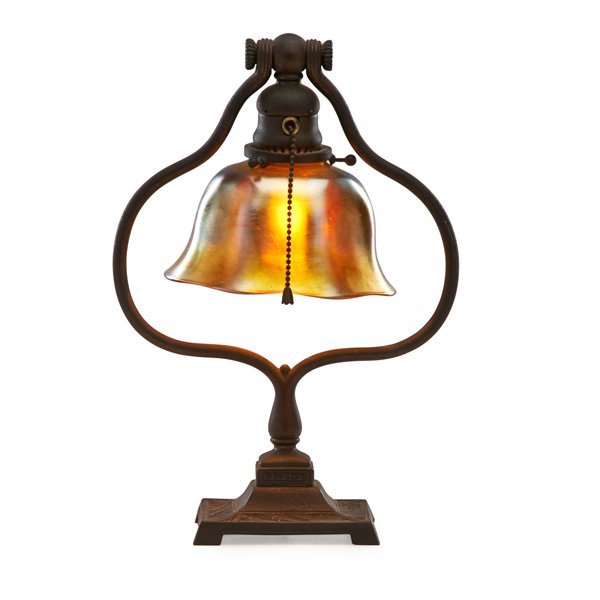 TIFFANY STUDIOS American Indian desk lamp: TIFFANY STUDIOS American Indian desk lamp with gold Favrile glass shade, New York, 1900s; Acid-etched bronze, Favrile glass, single socket; Base stamped TIFFANY STUDIOS NEW YORK 665, shade etched L.C.