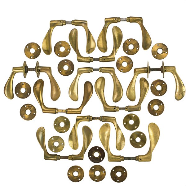 ARNE JACOBSEN Eleven door handles: ARNE JACOBSEN (1902 - 1971) CARL F. PETERSEN Set of eleven patinated brass door handles, Denmark, 1960s; Unmarked; With back plates: 4 3/4" x 2" x 7" Note: Designed for the Scandinavian Airlines Syste