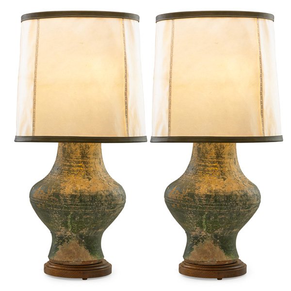 SCOTT CORNELIUS DESIGN STUDIO Pair of table lamps: SCOTT CORNELIUS DESIGN STUDIO Pair of table lamps, New York, 2000s; Re-purposed urns (possibly Han Dynasty), patinated brass, stained oak, double sockets, goatskin parchment and leather shades; Unmark