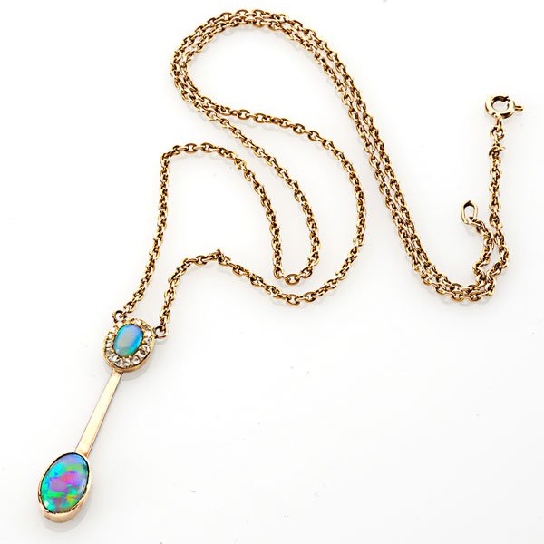 EDWARDIAN BLACK OPAL AND ROSE CUT DIAMOND LAVALIERE: Black opal surmount framed by rose cut diamonds suspends ovular bezel set black opal, drop affixed on chain; Marked 9 ct.; Chain 19", drops 1 1/2"; 4.4 dwt.