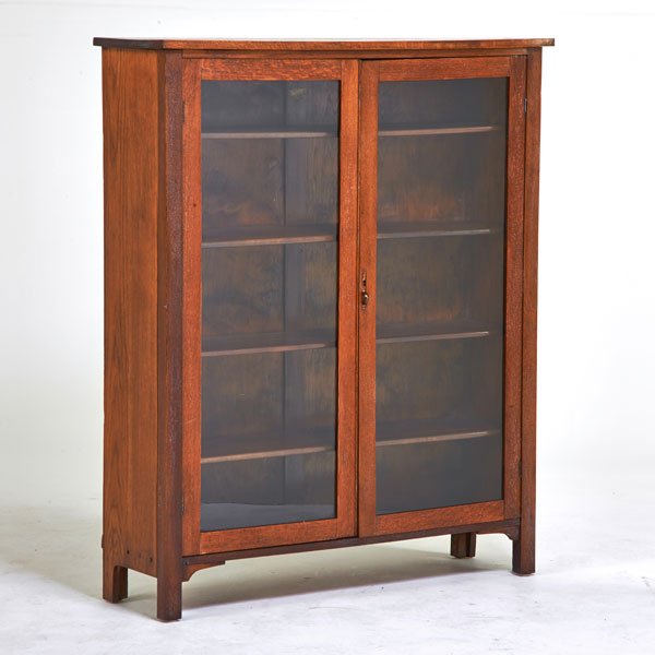 STICKLEY BROTHERS: Two door bookcase, Grand Rapids, MI, ca. 1915; Quartersawn oak, glass, patinated metal; Quaint metal tag; 53" x 44" x 12 1/2"