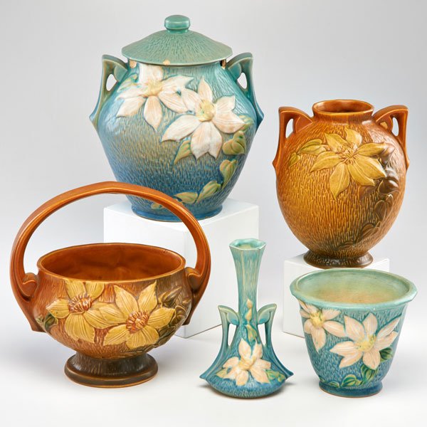 ROSEVILLE: Five Clematis pieces: brown basket, brown vase, blue bud vase, small blue planter, and blue cookie jar with lid, Zanesville, OH, 1944; All marked; Tallest: 10" x 9" dia.