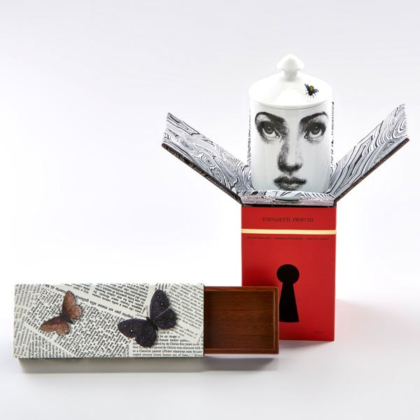 PIERO FORNASETTI: L'Ape" lidded candle and "Ultime Notizie" sliding box, both in original boxes, Italy, 2000s.; Glazed earthenware, enameled metal, mahogany; Candle silkscreened Fornasetti Profumi, box with foil sticke