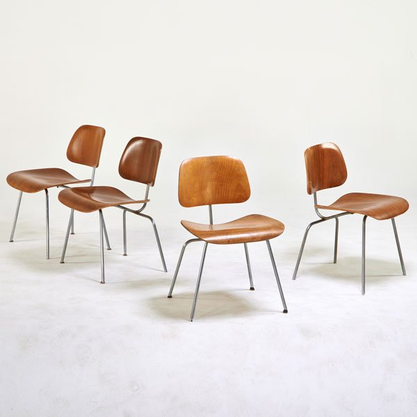 CHARLES AND RAY EAMES; HERMAN MILLER: Four dining chairs (DCMs), Zeeland, MI, 1950s; Chromed steel, walnut plywood; One with foil label; 29 1/2" x 19 1/2" x 19 1/2"