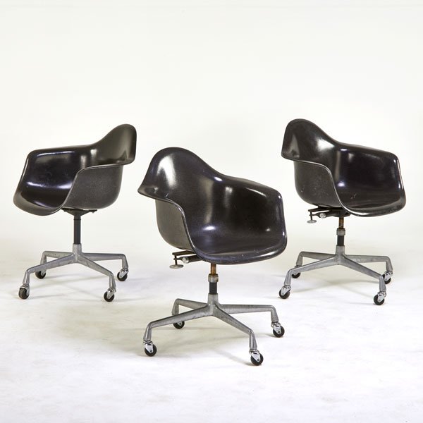 CHARLES AND RAY EAMES; HERMAN MILLER: Three Shell armchairs on castors, Zeeland, MI, 1960s; Plastic reinforced fiberglass, enameled steel, polished aluminum; Raised signatures; 33 1/2" x 25 1/2" x 22"
