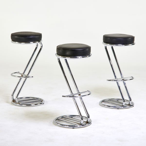 STYLE OF GILBERT ROHDE: Three bar stools, 1970s; Chromed steel, leather; Made in UK label; 32" x 13 1/2" dia.