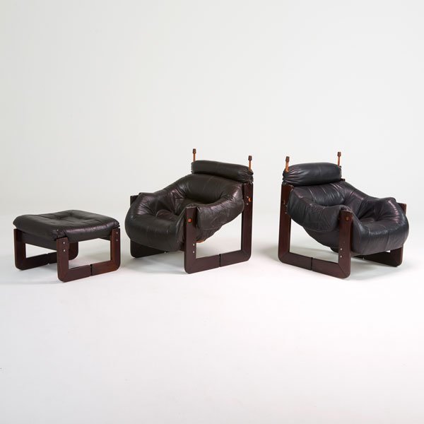 PERCIVAL LAFER: Two lounge chairs, one black and one brown, and matching ottoman, Brazil, 1970s; Jacaranda, leather, chromed steel; Metal tag to one chair; Chairs: 36" x 32" x 36", ottoman: 16" x 22" x 24"