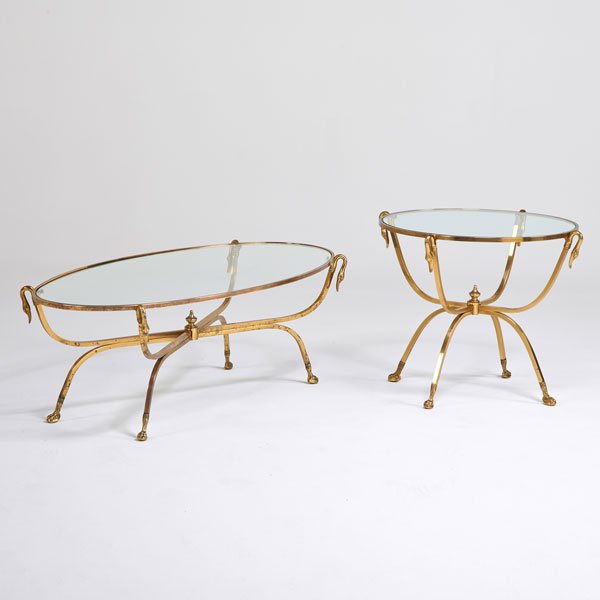 STYLE OF MAISON JANSEN: Coffee table and matching side table, Italy, 1970s; Solid brass, glass; Stamped Italy; Coffee table: 17 1/4" x 54" x 26", side table: 23" x 29" dia.