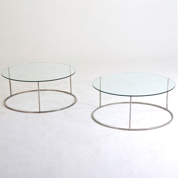 MILO BAUGHMAN; DESIGN INSTITUTE OF AMERICA: Pair of low tables, USA, 1980s; Chromed steel, glass; 17 1/2" x 41 1/2" dia.