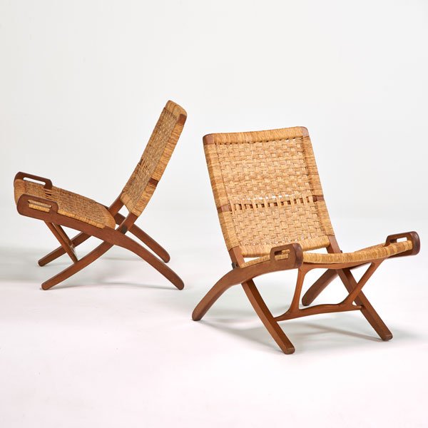 STYLE OF HANS WEGNER: Pair of folding lounge chairs, Denmark, 1960s; Teak, brass, woven cord; Unmarked; 31" x 23 1/2" x 30"