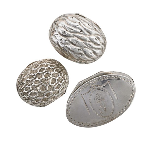 THREE ENGLISH SILVER NUTMEG GRATERS: Two walnut-shaped by Hillard and Thompson, Birmingham, late 19th c.; Oval grater with mark IP, c. 1790; Largest: 2 1/4"; 2.99 OT