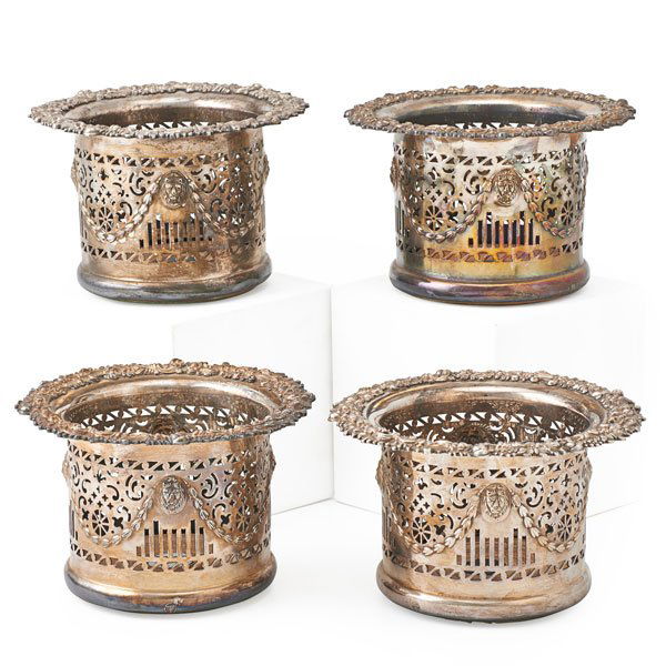 ELLIS-BARKER SILVER PLATED WINE BOTTLE COASTERS: Four, reticulated with lion masks and gadrooned detail, England, 19th c.; 5" x 7 1/2" dia.