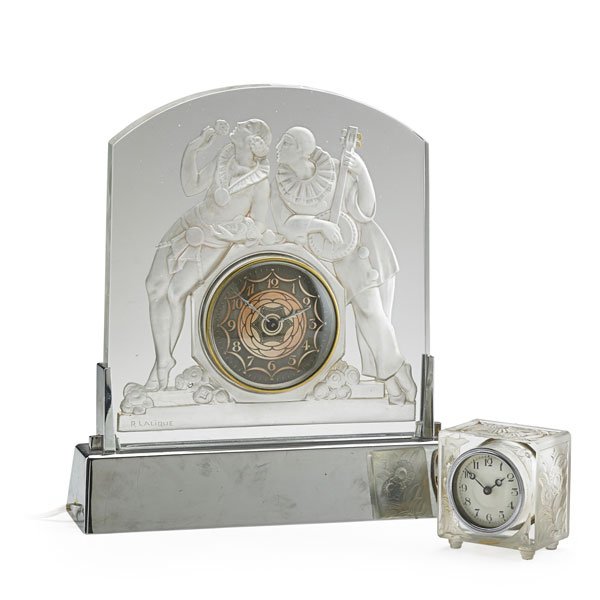 STYLE OF LALIQUE: Two clocks in clear and frosted glass, smaller of square form, the larger etched with a courting couple; Each bearing the signature "Lalique"; Larger: 12"; Provenance: Estate of a Private Collector, N