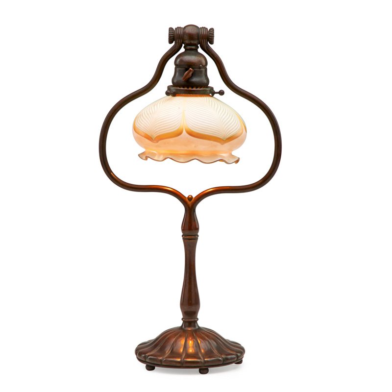 TIFFANY STUDIOS; QUEZAL Desk lamp: QUEZAL TIFFANY STUDIOS Tiffany Studios desk lamp with Quezal pulled feather shade, New York, 1900s; Bronze, glass, single socket; Base stamped TIFFANY STUDIOS NEW YORK 424, shade etched QUEZAL; 18" x 