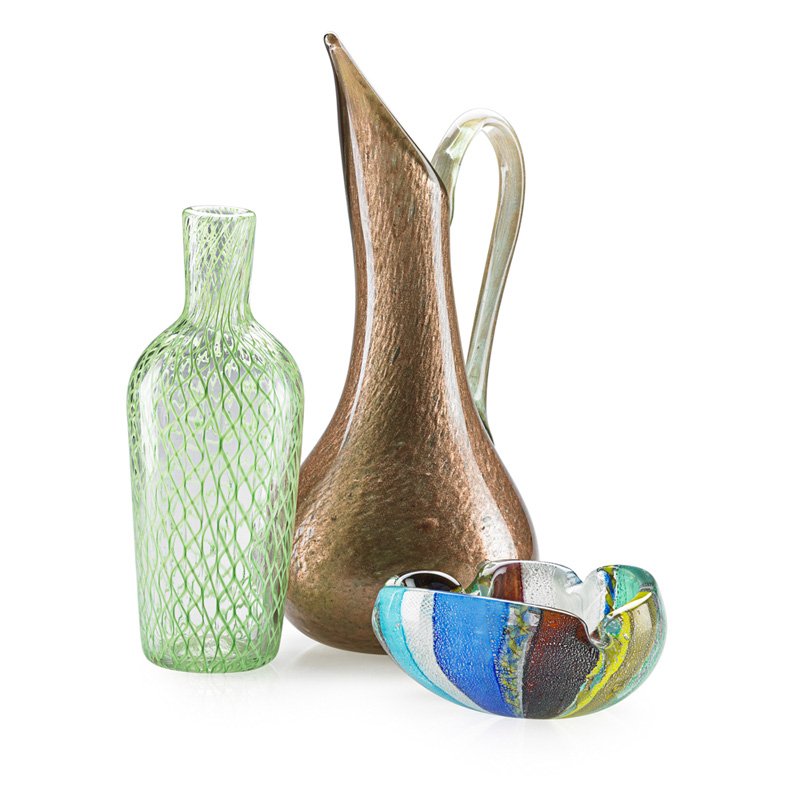 DINO MARTENS Pitcher, bottle, and ashtray: DINO MARTENS (1894 - 1970) Aventurina glass pitcher, Oriente glass ashtray, and a filigrana glass bottle, Murano; All unmarked; Pitcher: 16 1/4" x 8" x 6 1/2" Published: Heiremans, Dino Martens Murane