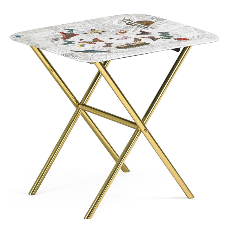 PIERO FORNASETTI Tray table: PIERO FORNASETTI (1913 - 1988) Tray table, "Oggetti Sparsi su Giornale" (Scattered Objects on Newspaper), Italy, 1990s; Transfer-decorated and enameled metal, brass, vinyl straps; Sticker label to tra