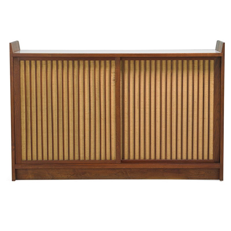 GEORGE NAKASHIMA Custom cabinet: GEORGE NAKASHIMA (1905 - 1990) NAKASHIMA STUDIOS Custom sliding door cabinet, New Hope, PA; Walnut, pandanus cloth, laminate; Unmarked; 43 1/4" x 66" x 22 3/4"