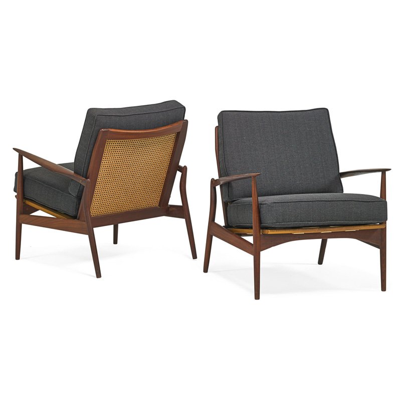 IB KOFOD-LARSEN; SELIG Pair of lounge chairs: IB KOFOD-LARSEN (1921 - 2003) SELIG Pair of lounge chairs, Denmark, 1960s; Sculpted teak, woven cane, upholstery; One branded MADE IN DENMARK; 31" x 29" x 30"