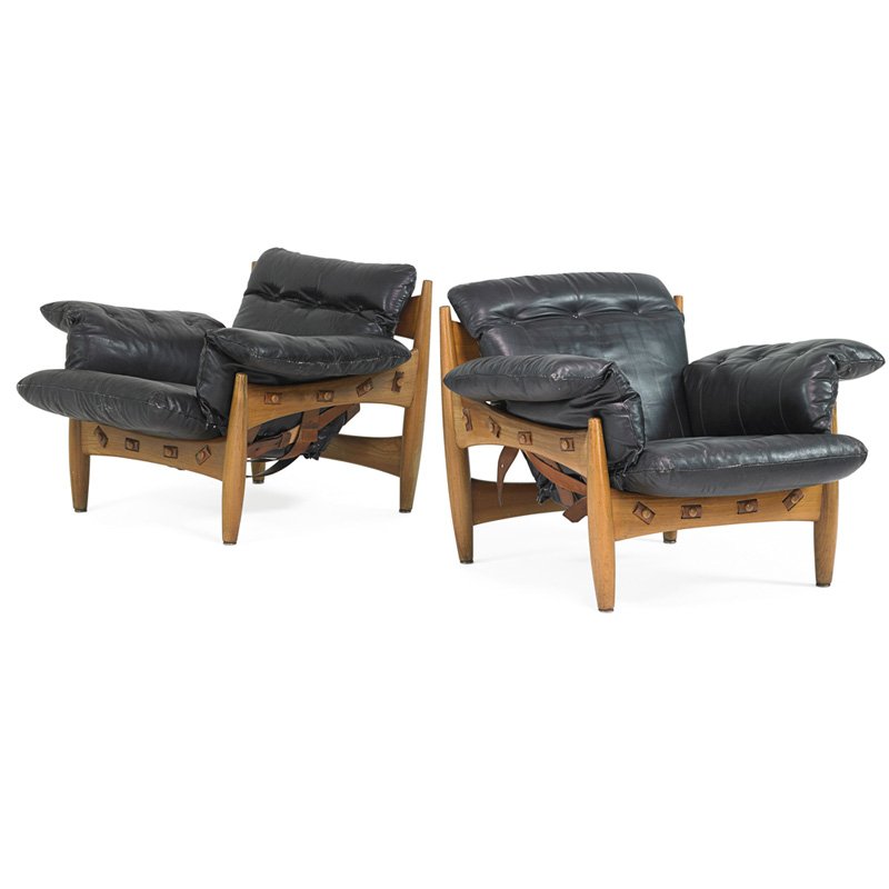 SERGIO RODRIGUES Pair of Sheriff lounge chairs: SERGIO RODRIGUES (b. 1927) ISA Pair of Sheriff lounge chairs, Italy, 1970s; Teak, leather; Metal manufacturer label; 31" x 33" x 34"