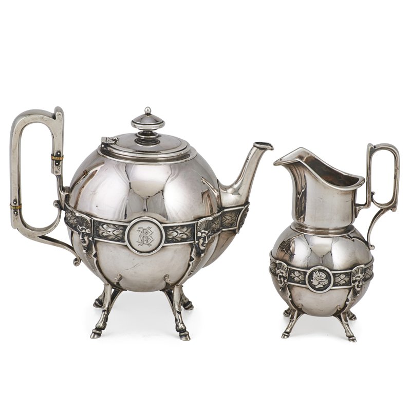 BALL, BLACK & CO. "MEDALLION" STERLING COFFEE SET: Two piece partial service: Spherical bodies banded by acanthus leaves and cameo medallions on tall hoof feet which transform to Pharaonic masks, loop handles, conical knopped finial, ca. 1872. Designe