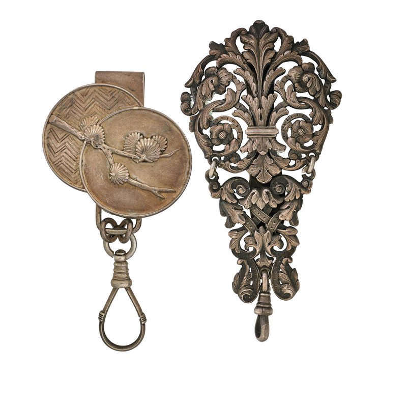 TWO STERLING CHATELAINE CLIPS BY TIFFANY & CO.: Japanesque chatelaine clip #3057, ca. 1873; Baroque clip, ca. 1890. Longest 4". 93 dwt.